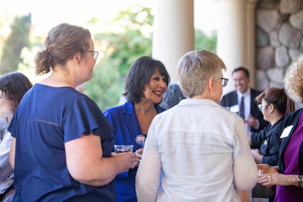 President Mantella talking with Faculty